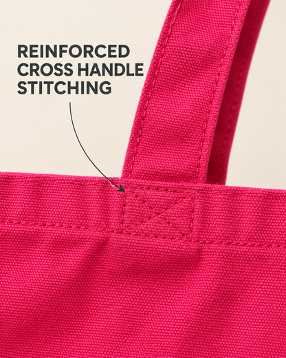 Close-up of reinforced handle stitching on the pink tote bag
