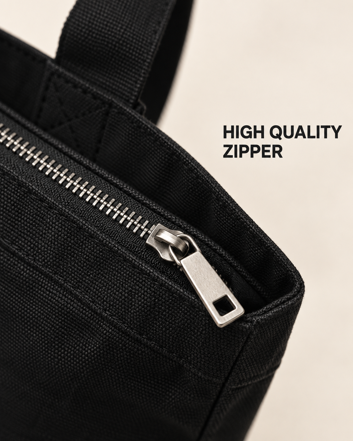 Close-up of the black tote bag zip closure