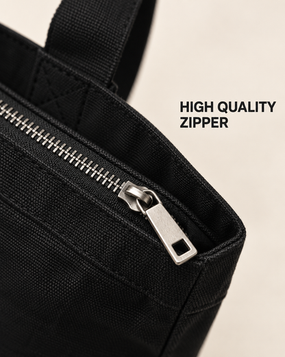 Close-up of the black tote bag zip closure